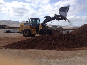 Bulldozer mixing a bulk order of Empire Builder soil for a bulk delivery order
